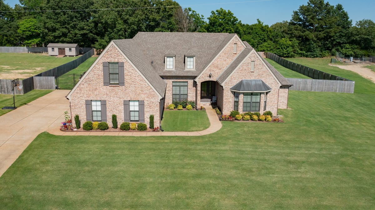 home with healthy green lawn and landscape