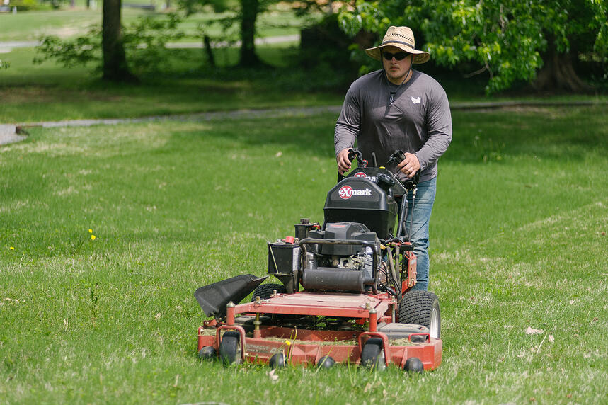 lawn care team mows lawn