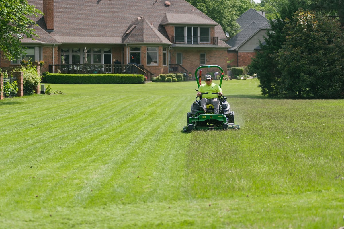 lawn being mowed by professional landscape maintenance company