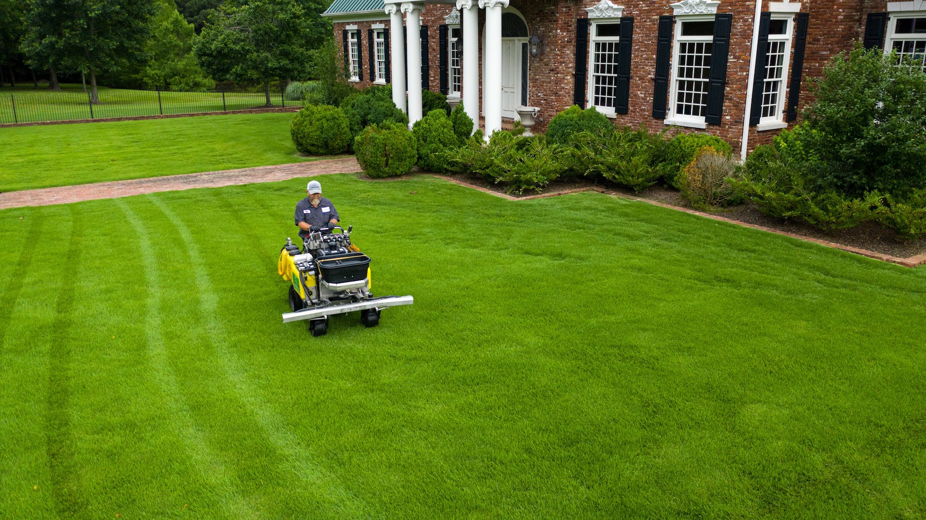 Lawn care technician applying fertilizer