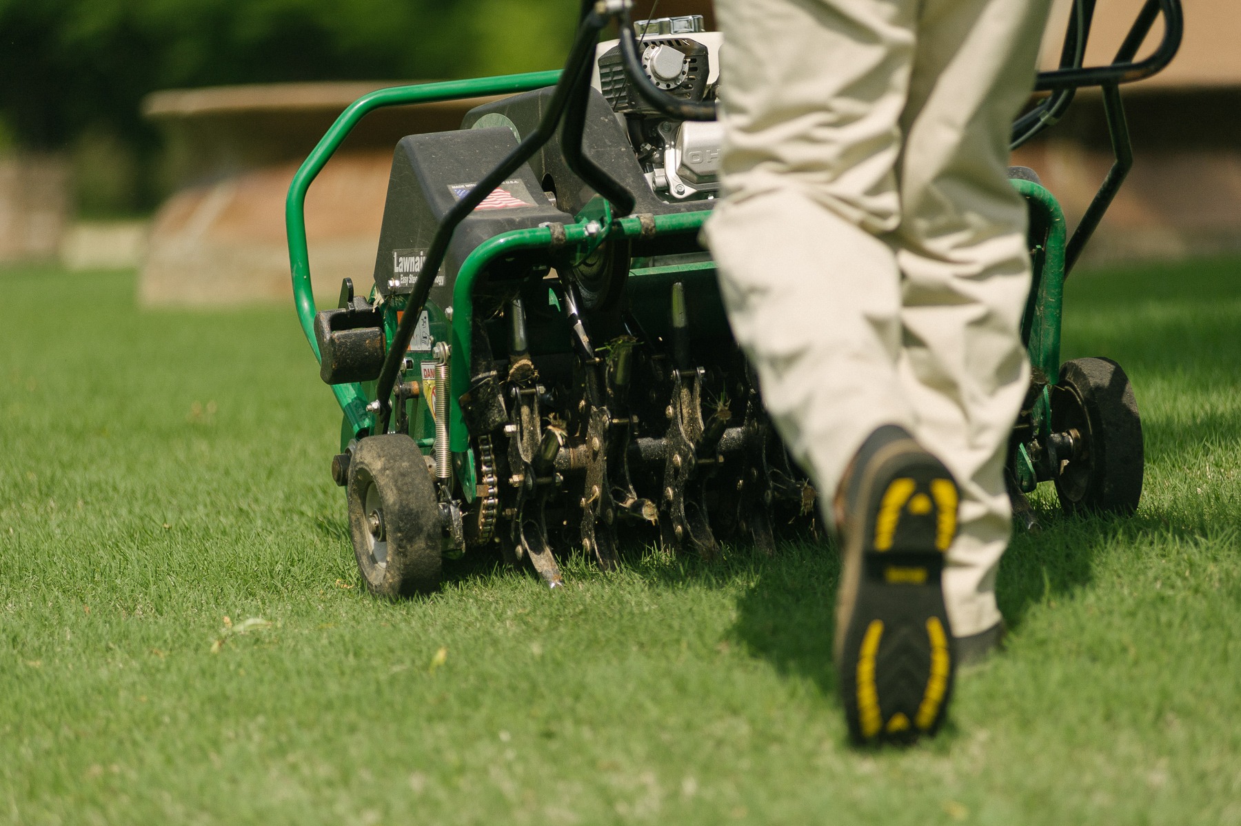 Master Lawn technician aerating a customers lawn