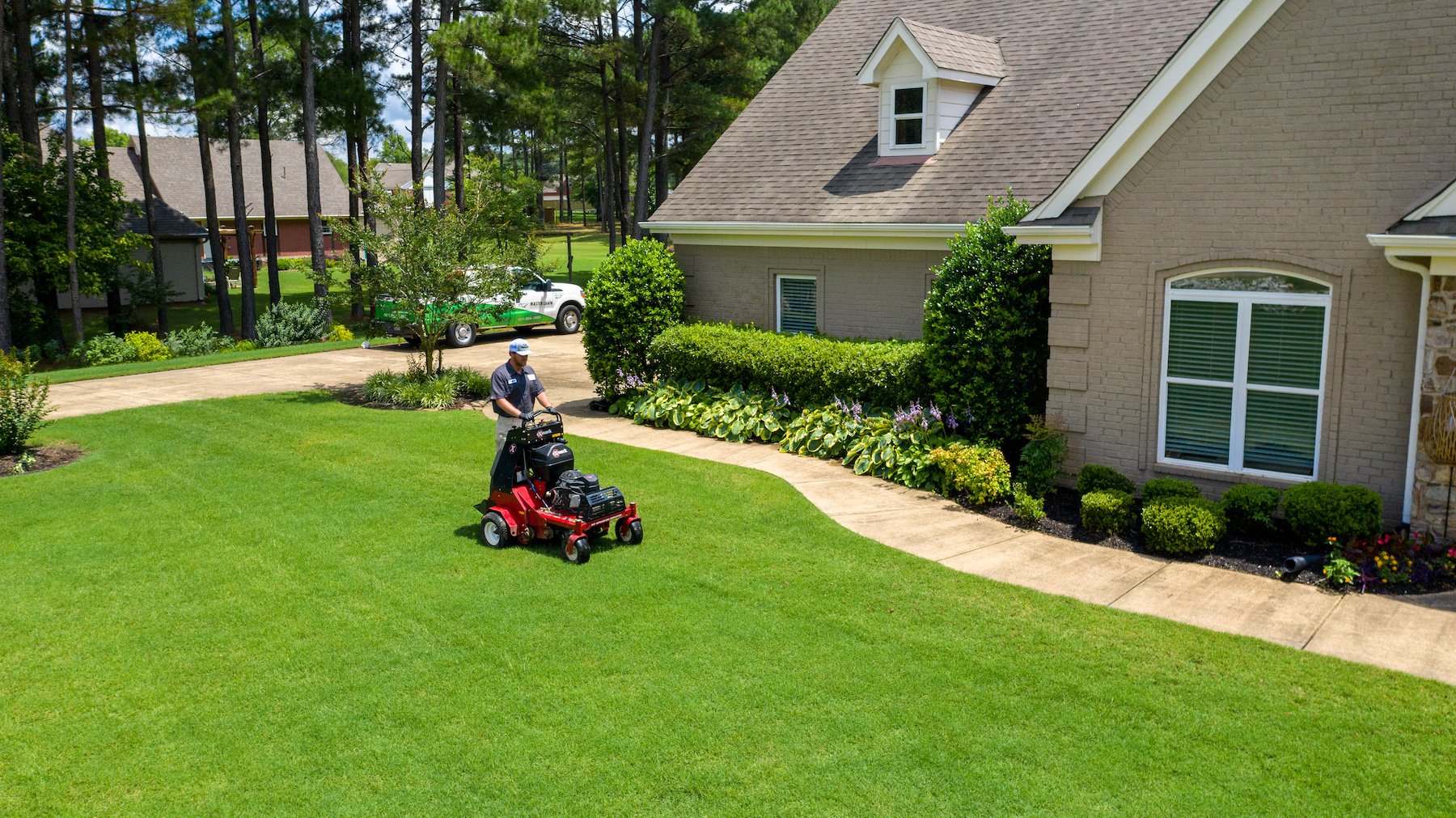 lawn care technician aerating 