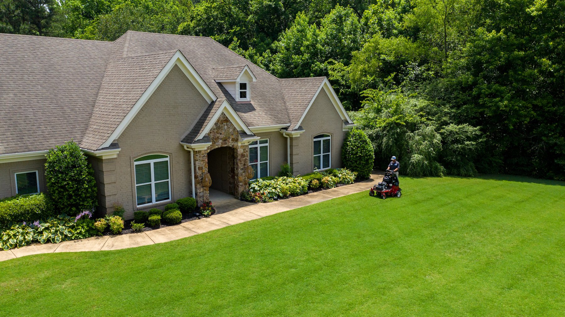 Master Lawn lawn care technician aerating lawn in Memphis, TN