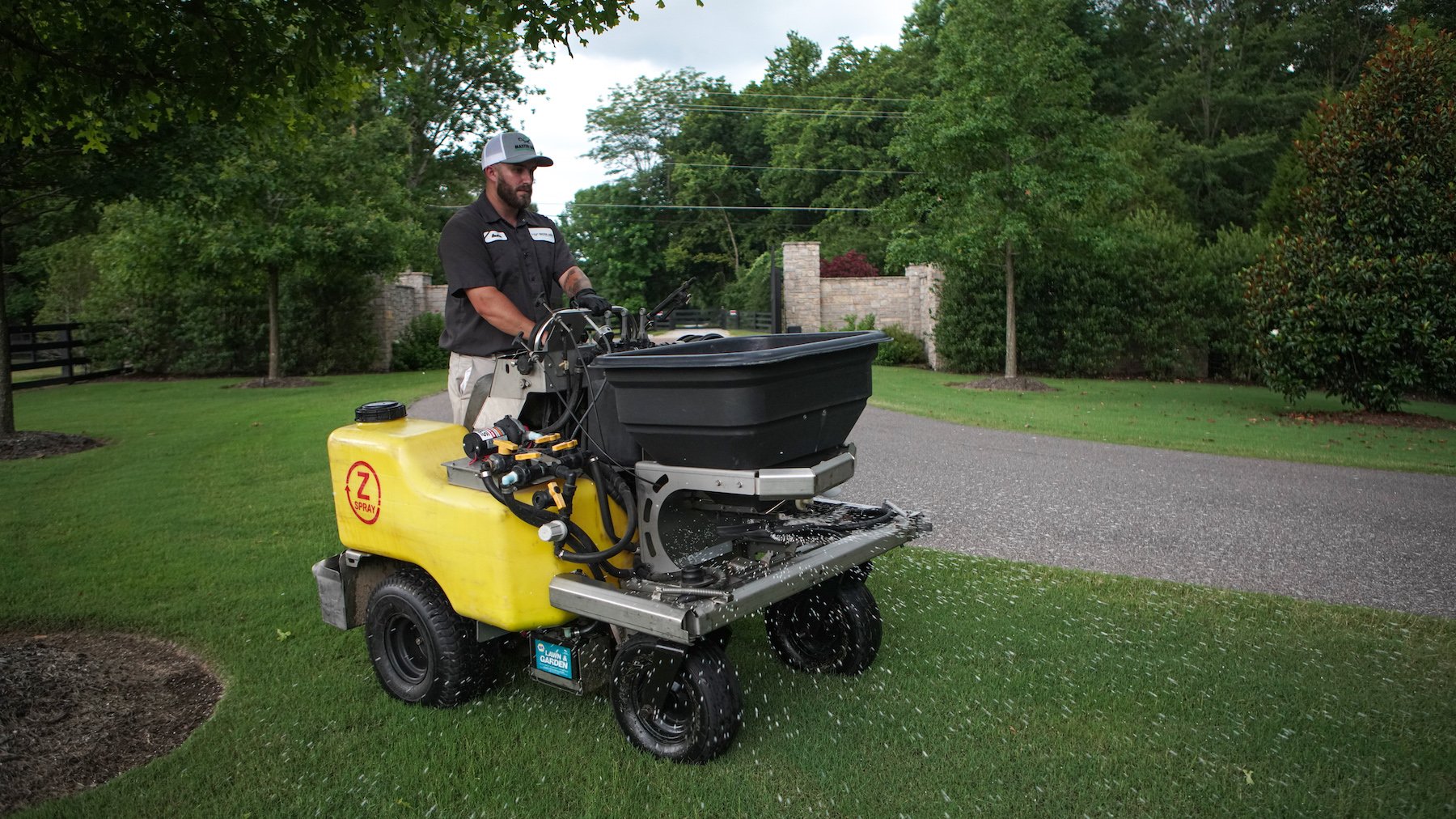 lawn care technician applying fertilizer