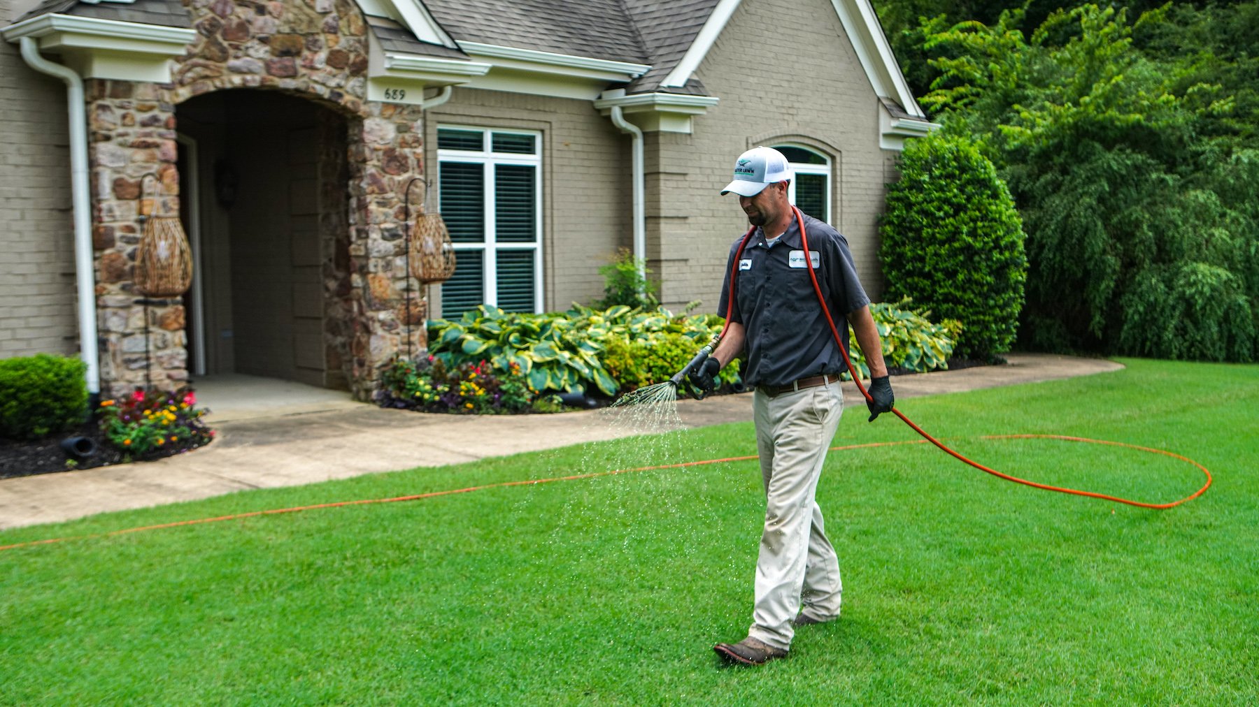 lawn care technician spraying 