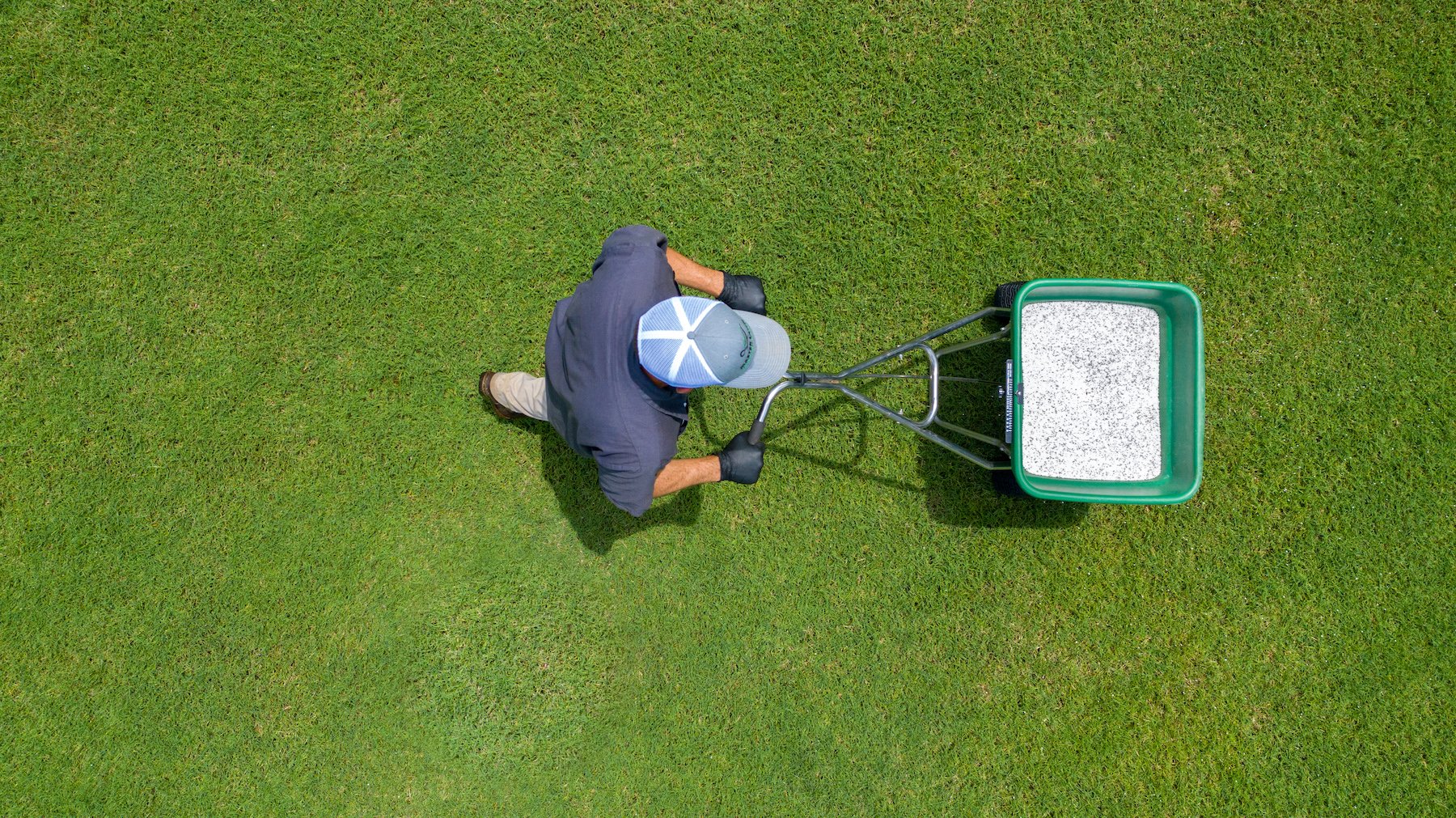technician applying last round of fertilizer