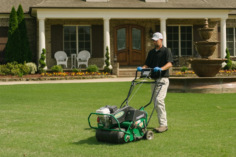 lawn technician aerating lawn