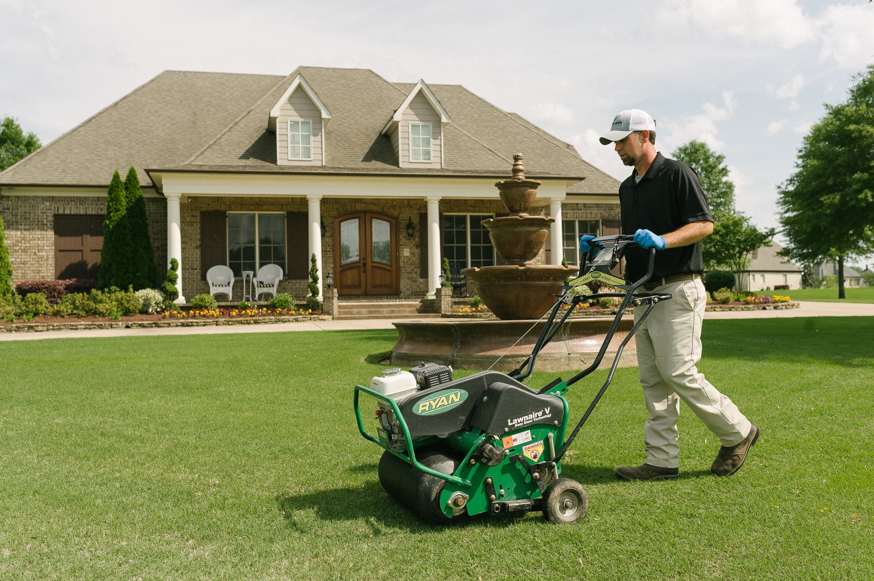 Lawn technician aerating lawn