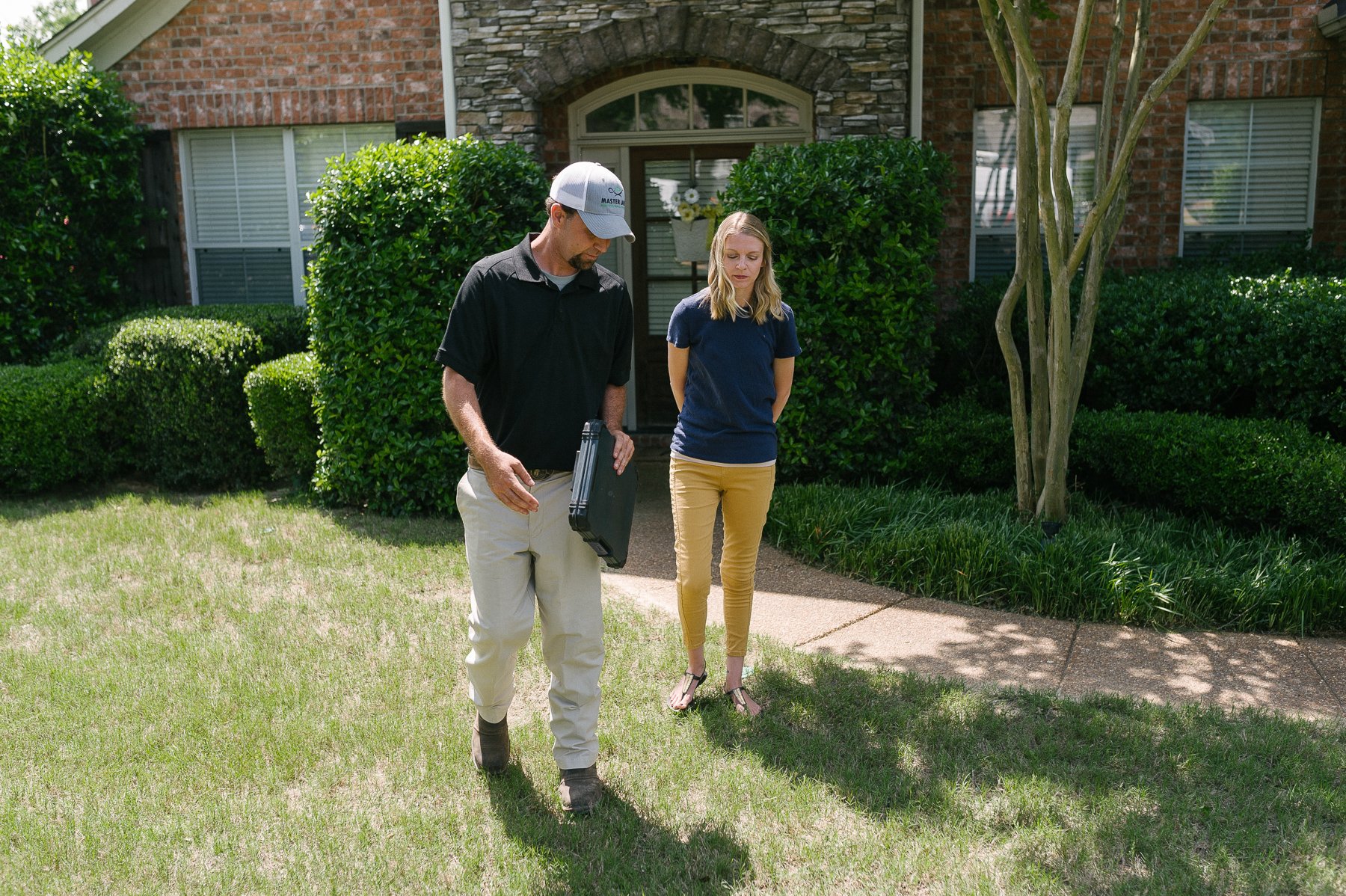 lawn care technician insoecting lawn