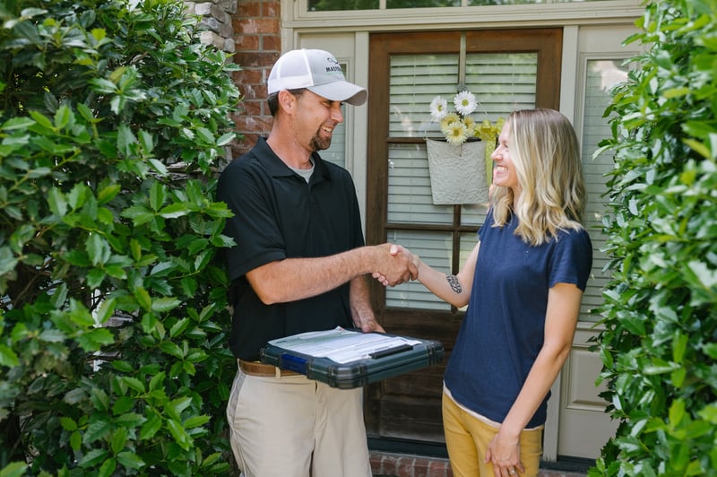 Master Lawn technician with happy customer