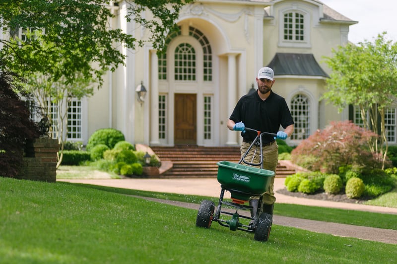 Master Lawn lawn care technician applying fertilizer