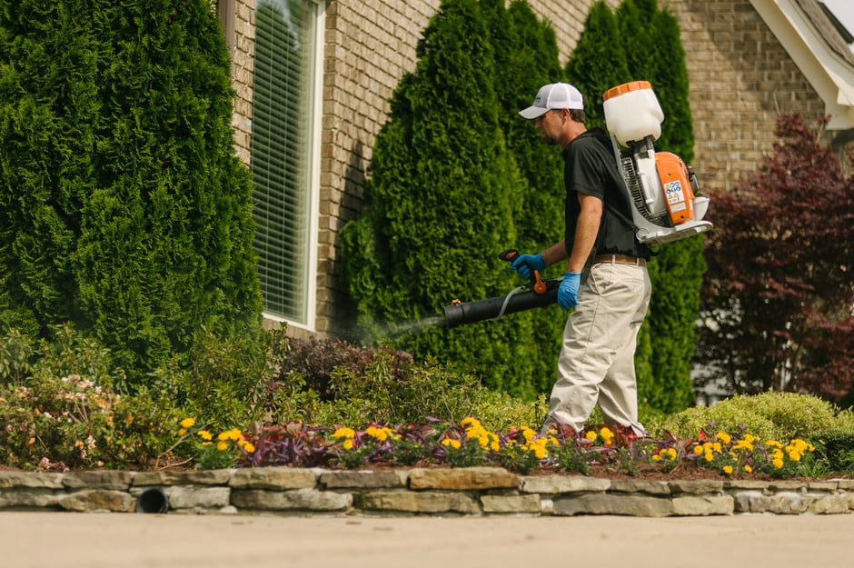 mosquito control technician spraying