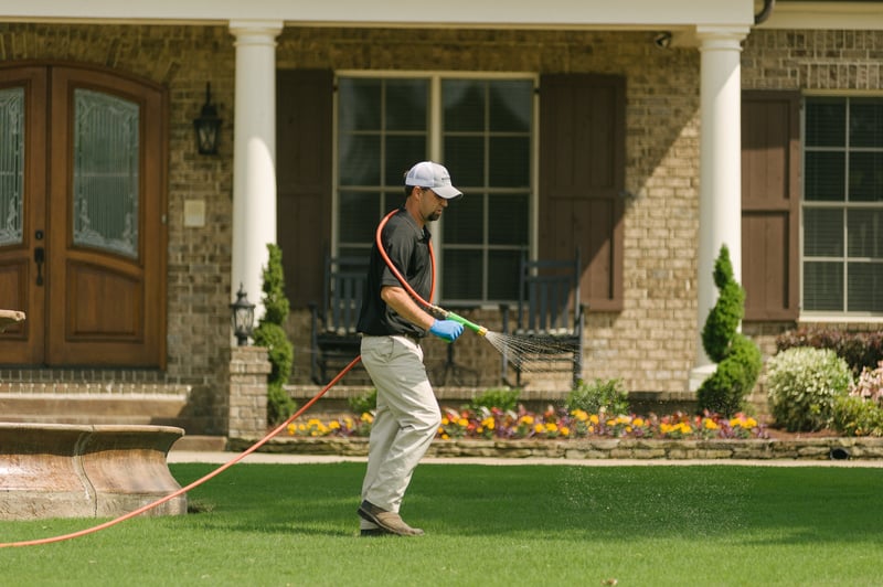 Master Lawn lawn care technician spraying lawn