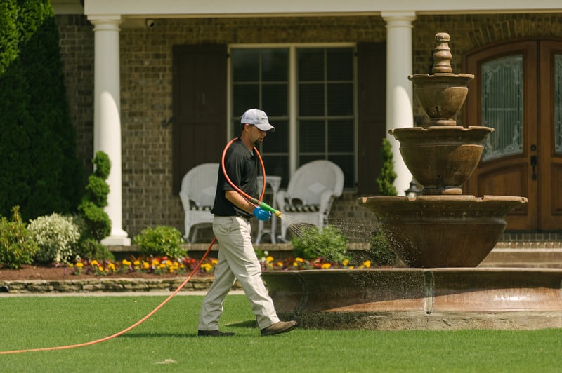 technician-spraying-lawn-hose-9