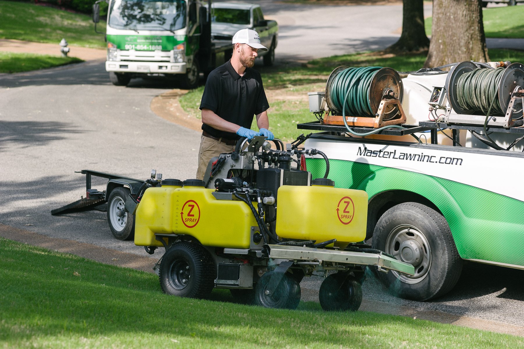 Master Lawn lawn care technician spraying lawn in Olive Branch, MS