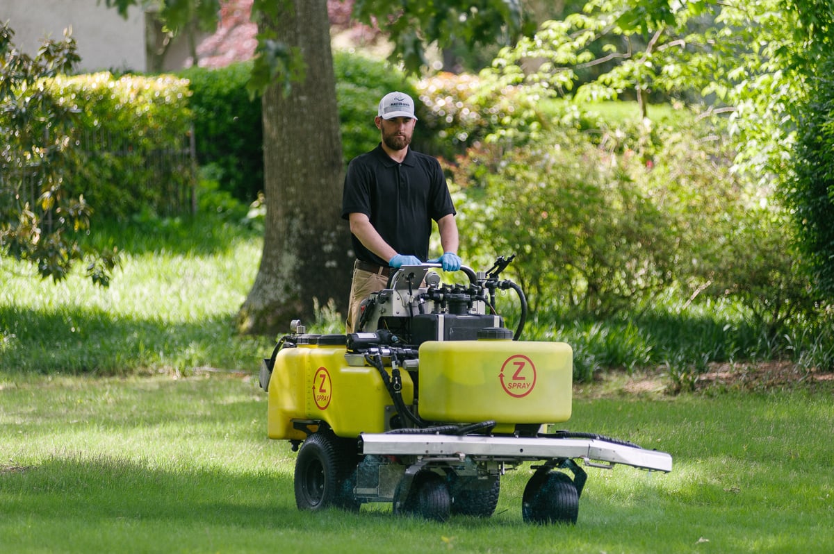 technician spraying liquid fertilizer