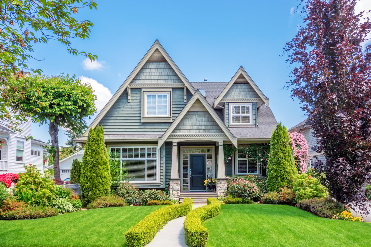 house with healthy trees and shrubs