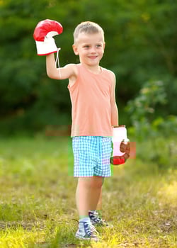 boy-boxing-gloves-grass
