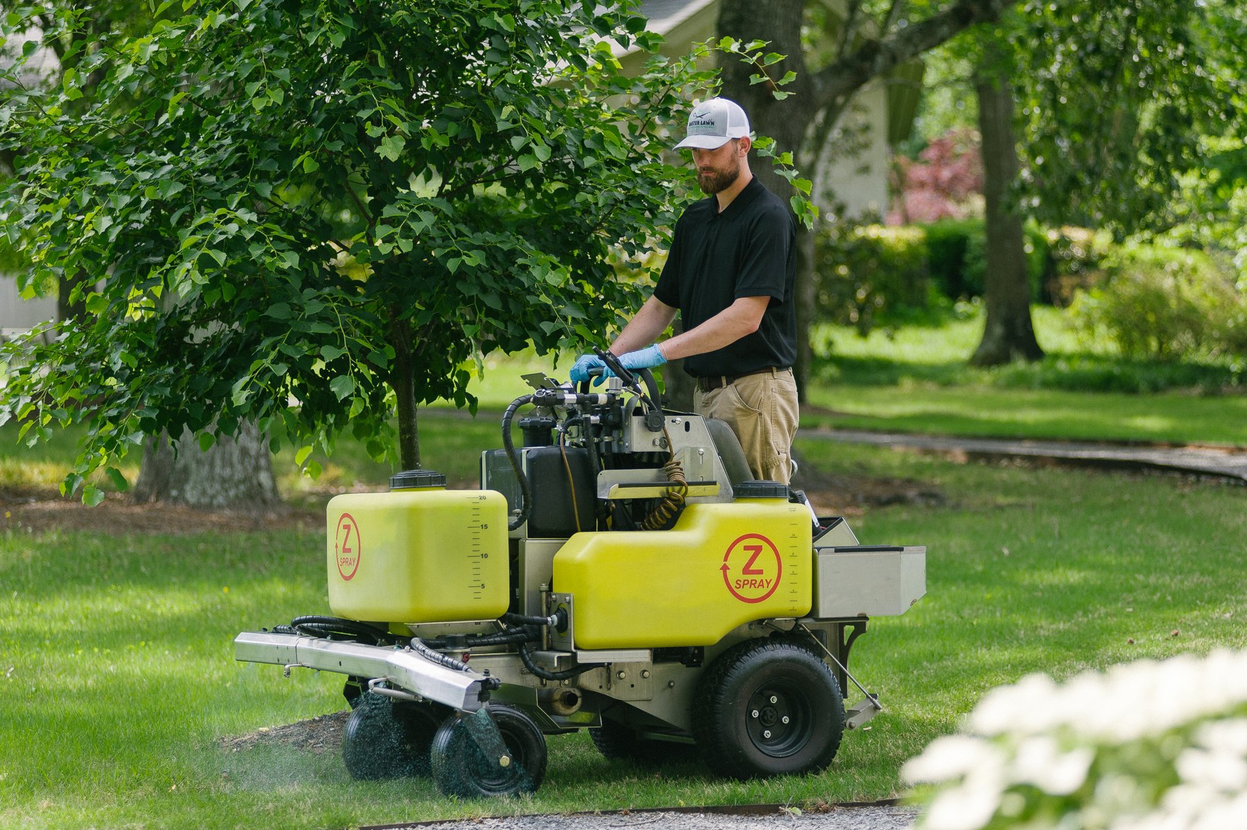 lawn technician spraying weed control