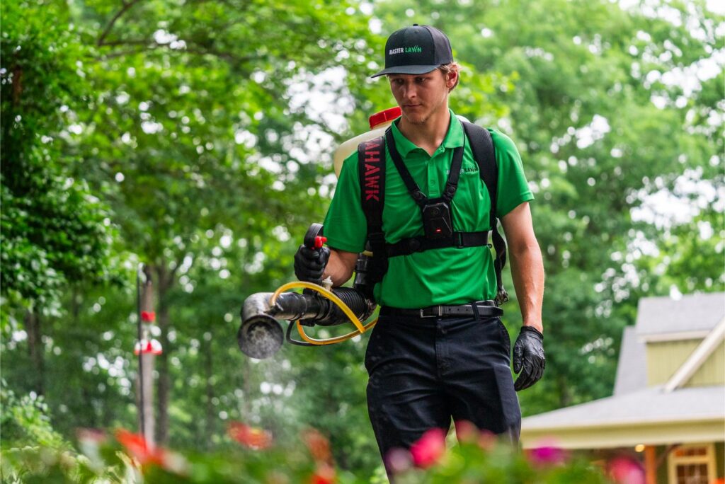 Lawn Care Technician Spraying Yard Treatment