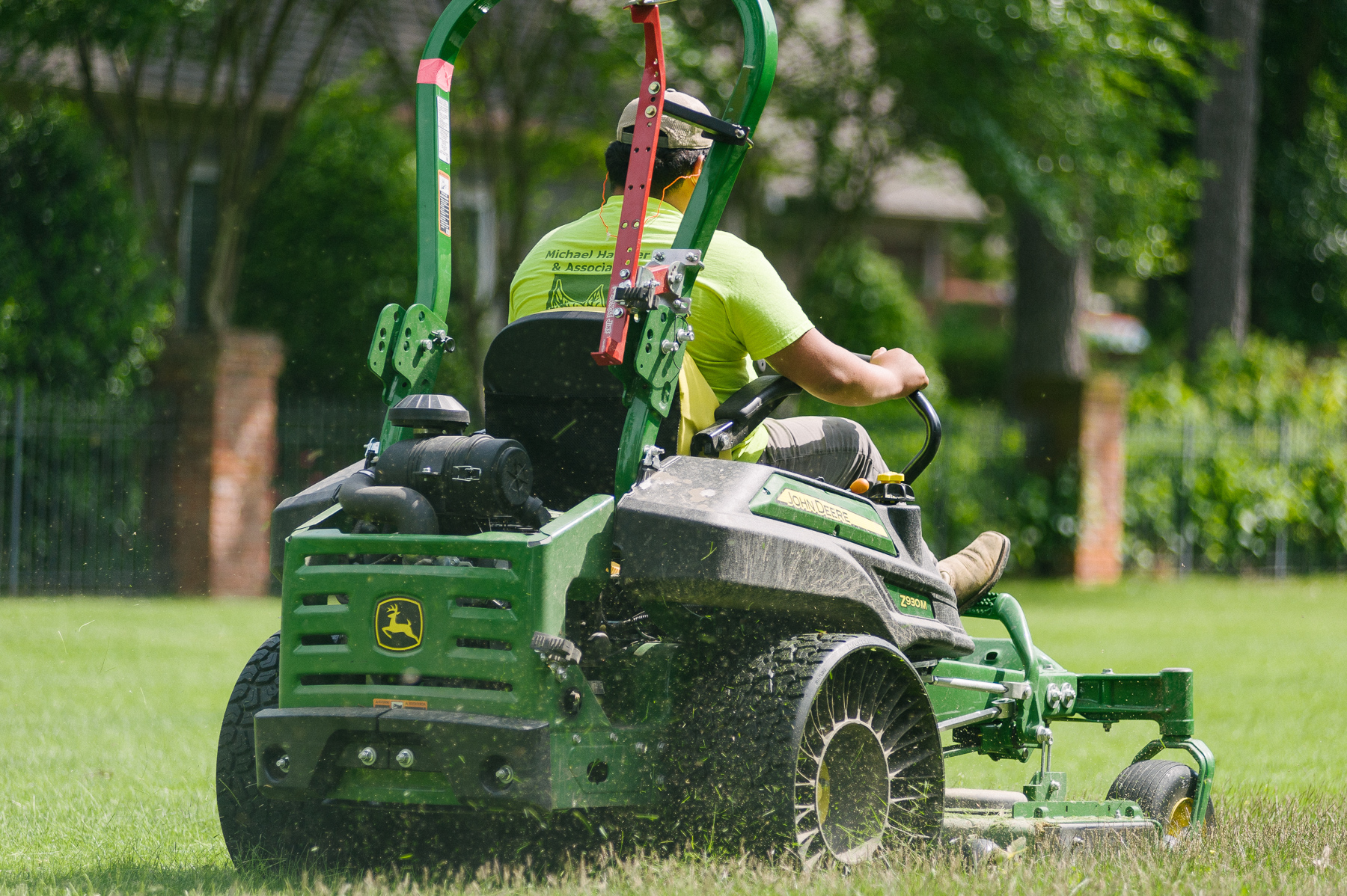 lawn technician mowing lawn in fall