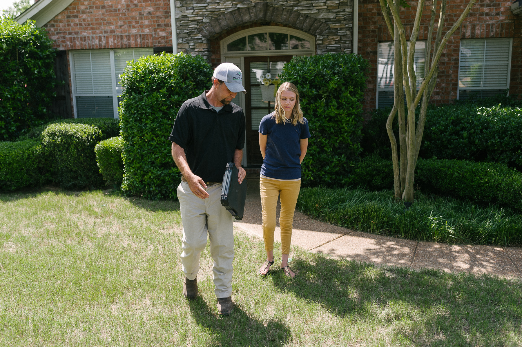 lawn care technician insoecting lawn