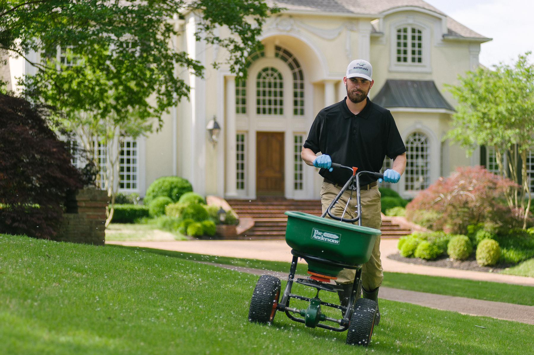 Lawn technician applying winter fertilizer