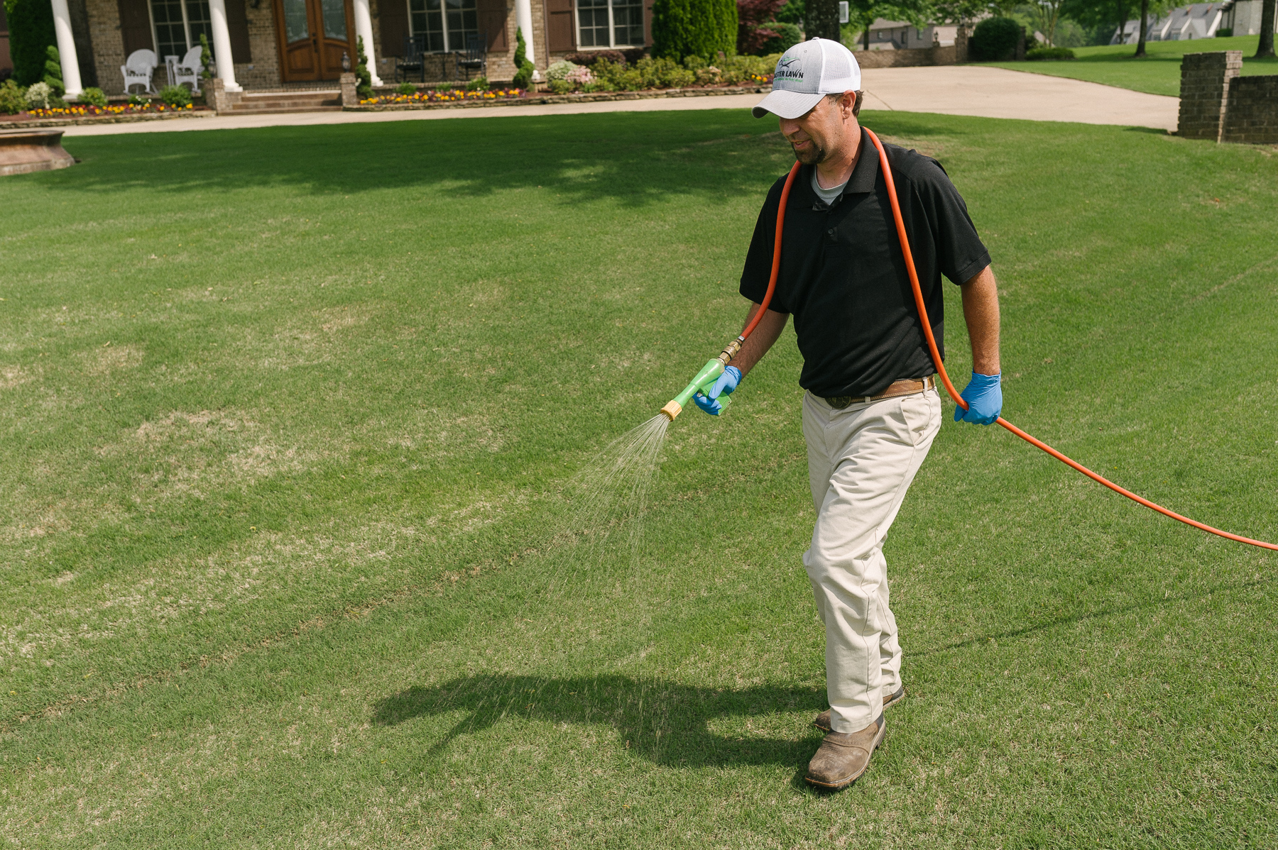 lawn care technician applying crabgrass preventer